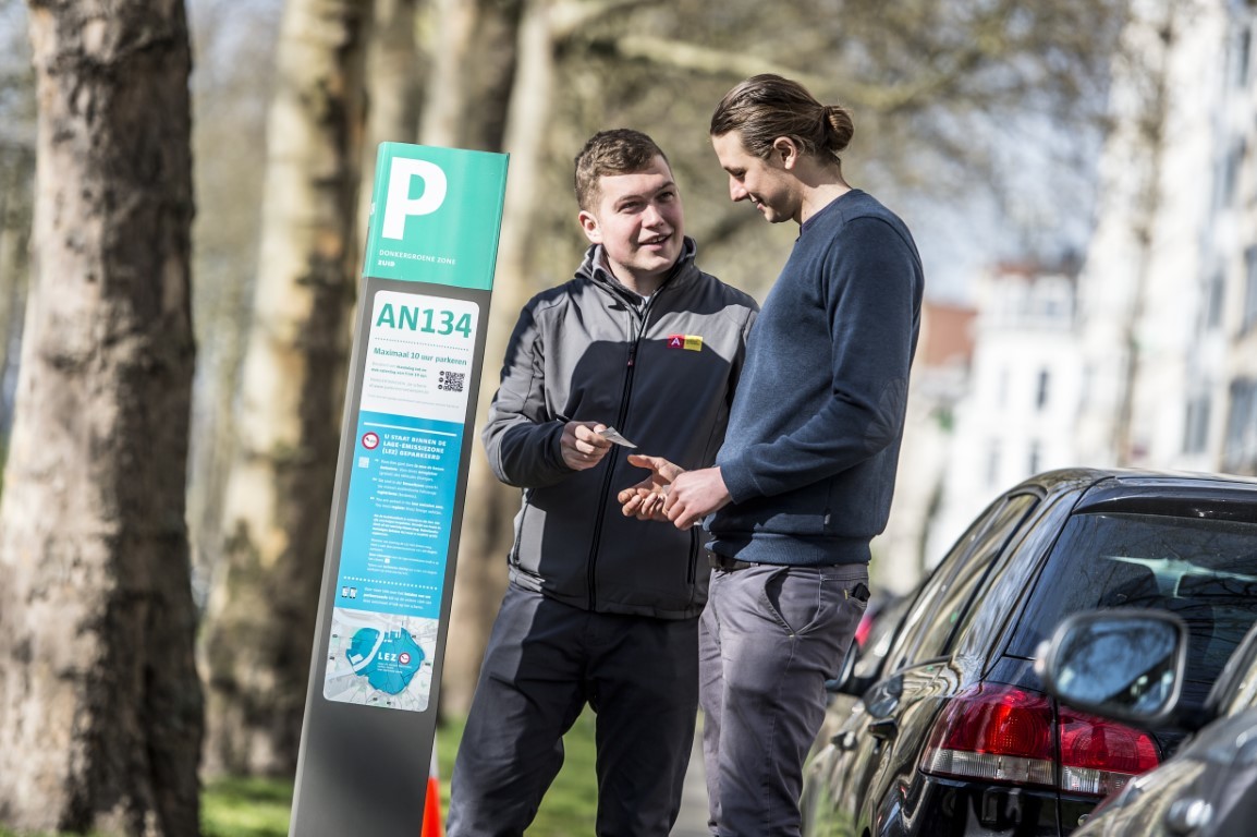 Parkeerwachter geeft uitleg aan een burger Parkeerwachter geeft uitleg aan een burger